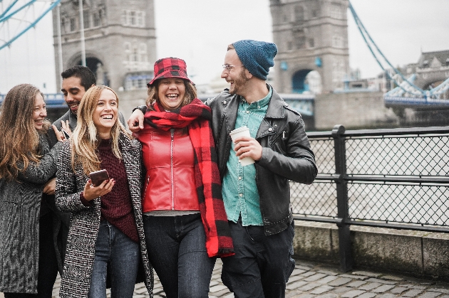 group of friends in front of london bridge