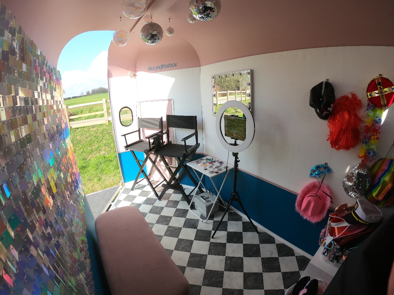 interior of horse box black and white floor pink walls props and make up chairs