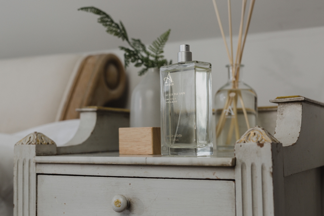 beauty products on a side table next to a mirror