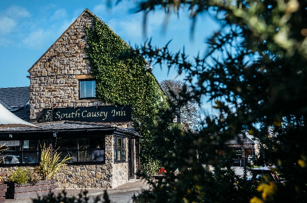 grey stone bistro pub with ivy on the outside