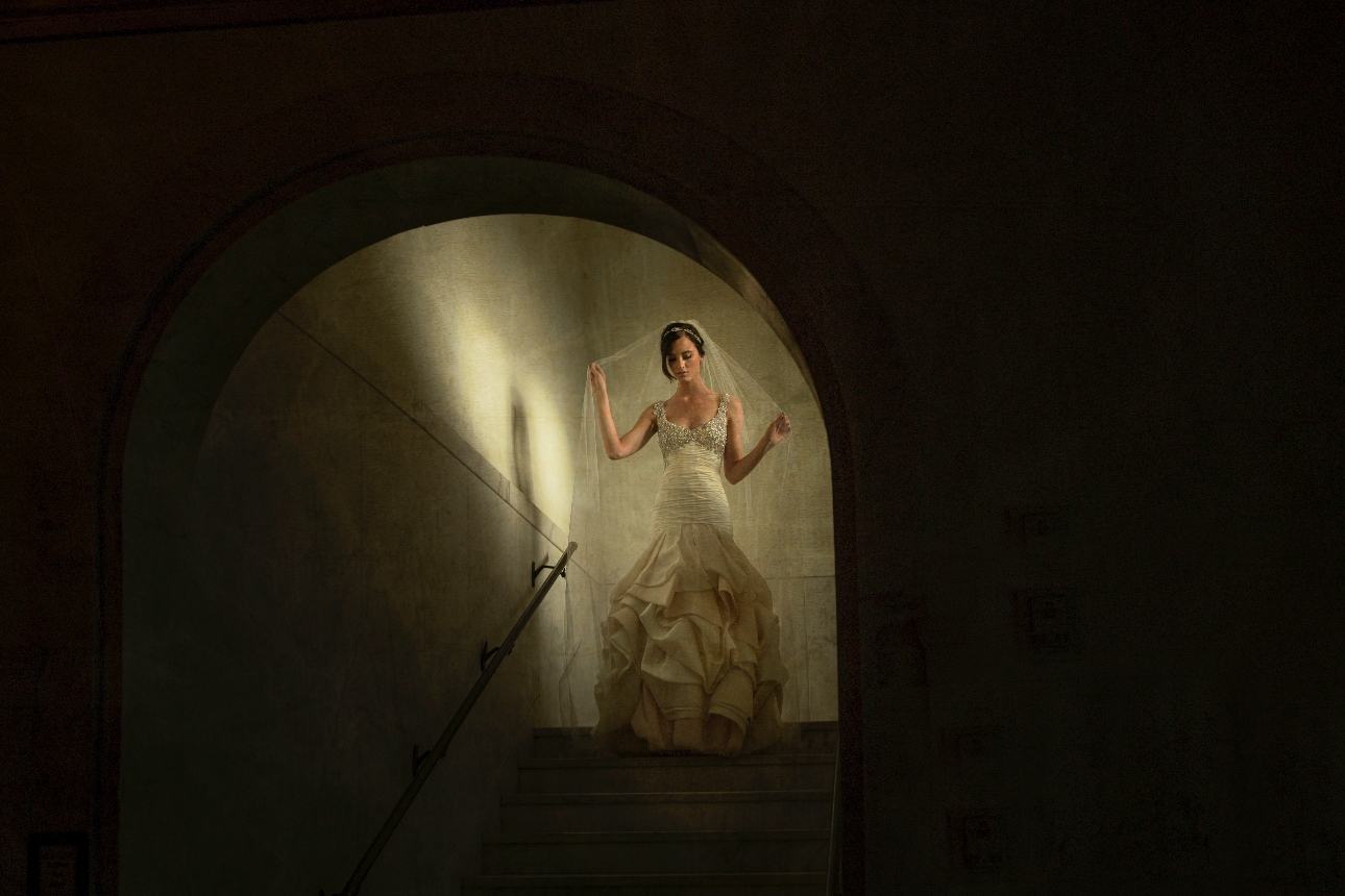 bride walking down the steps with the light sunlight on her