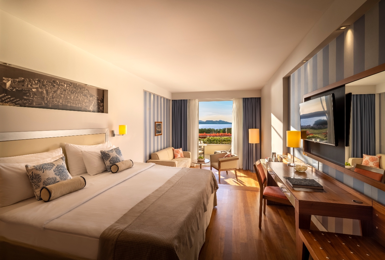 bedroom with large bed sofa and french door views with balcony