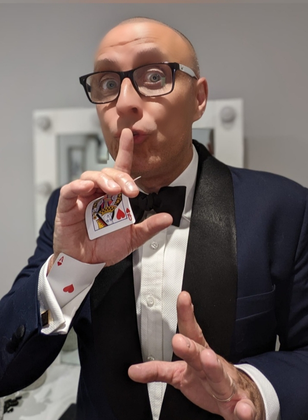 neil the magician in a suit with cards 