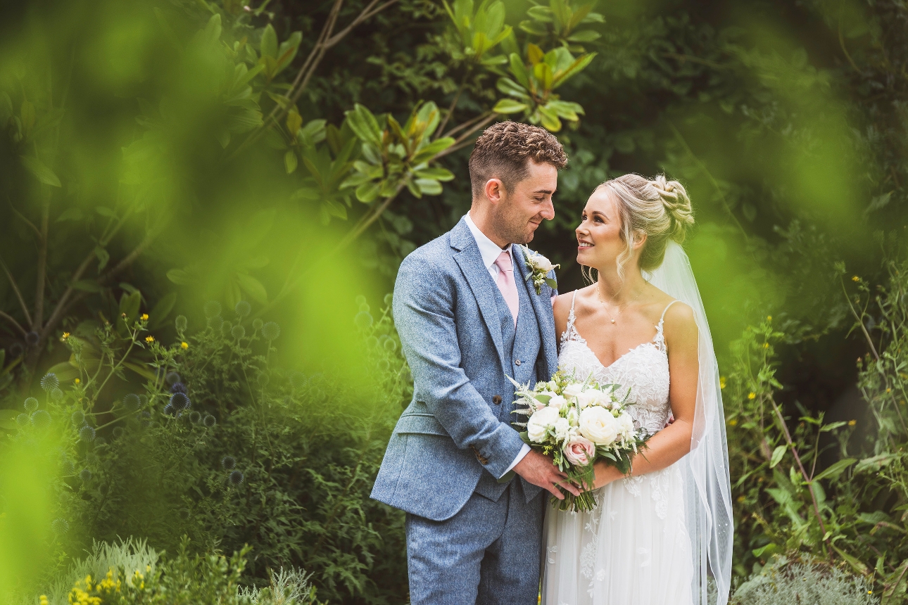 bride and groom looking at each other outside