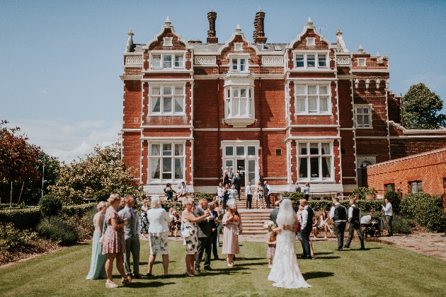 Wivenhoe House exterior red brick and white finish around windows manicured lawn area 