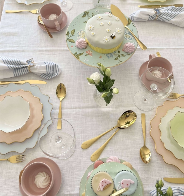 table image of pastel plates and mugs etc with gold cutlery 