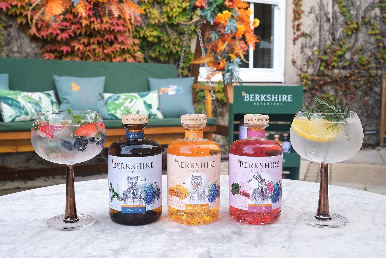 gin glasses and bottles on a table outside on a terrace