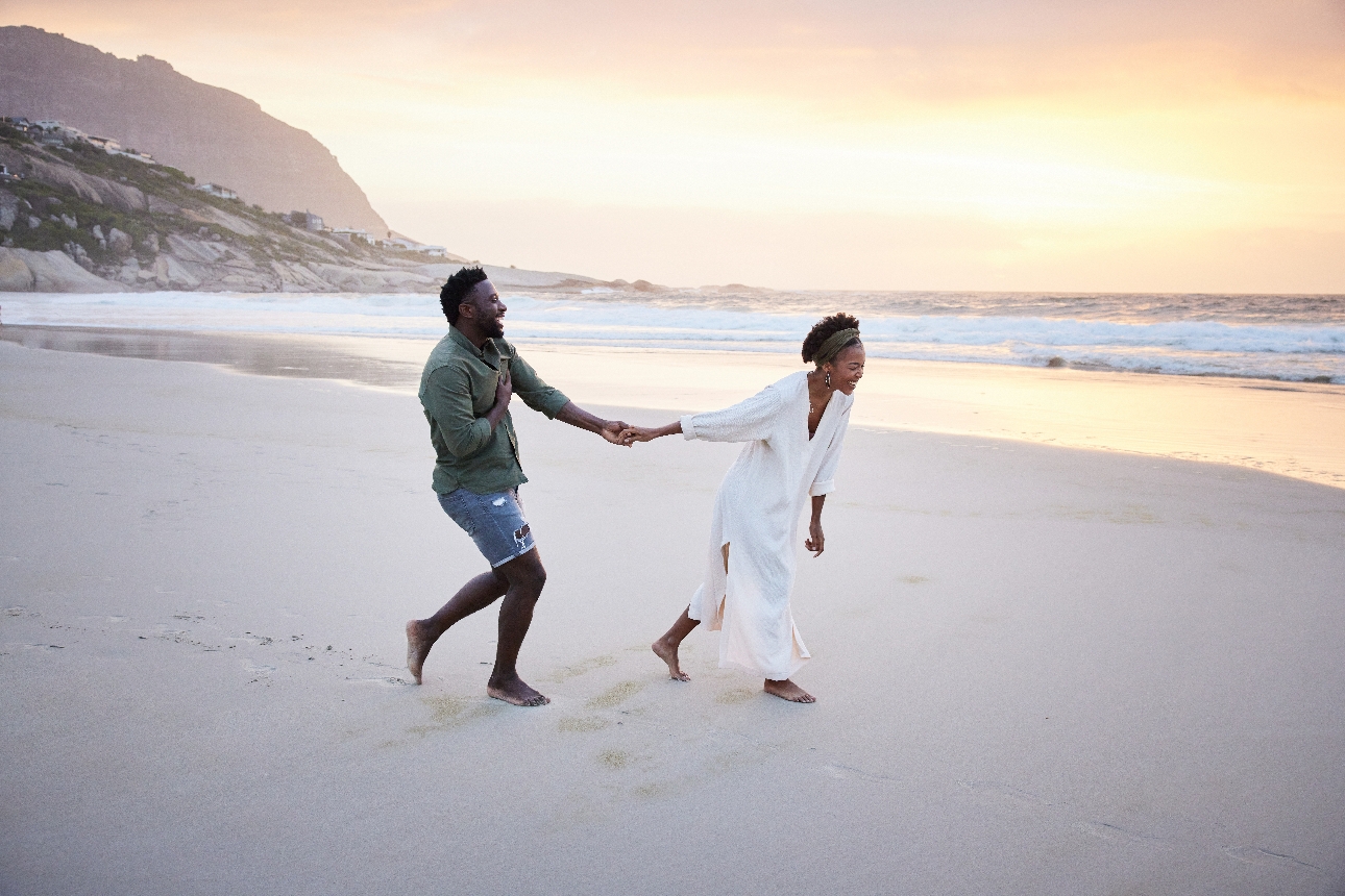 couple on their honeymoon on beach bare foot