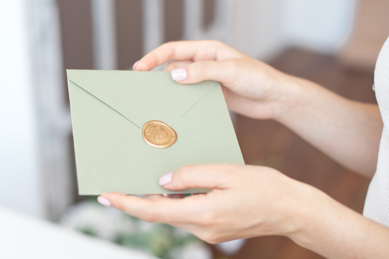 envelope in a bride's hands