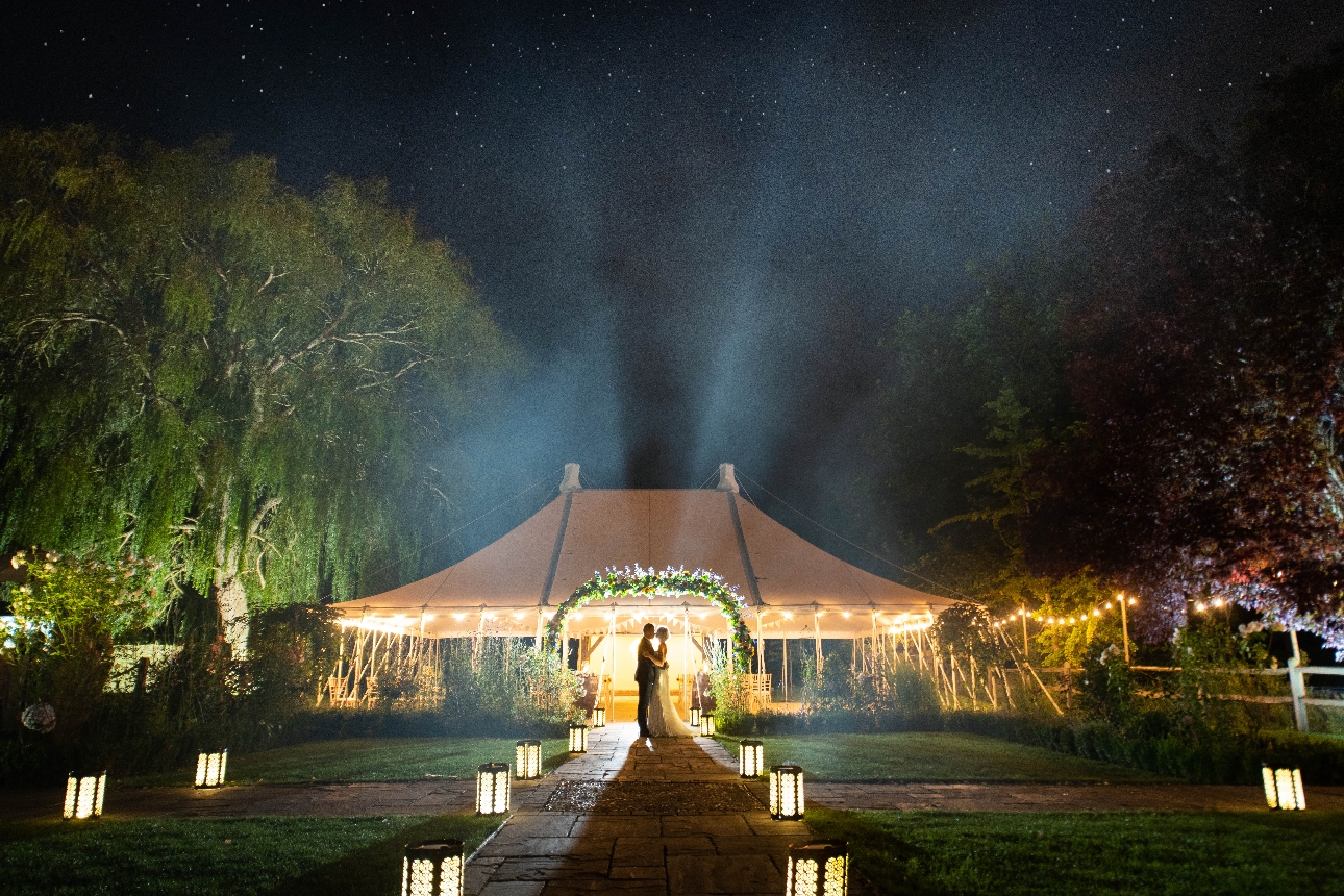 couple outside houchins wedding venue at night 