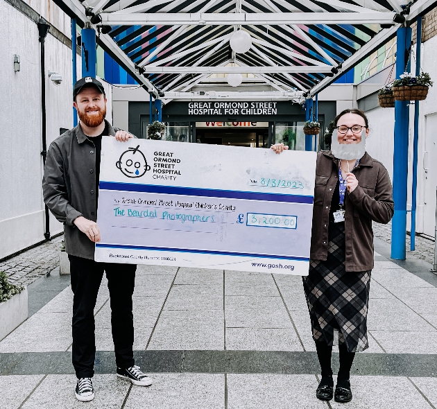 two people holding charity cheque