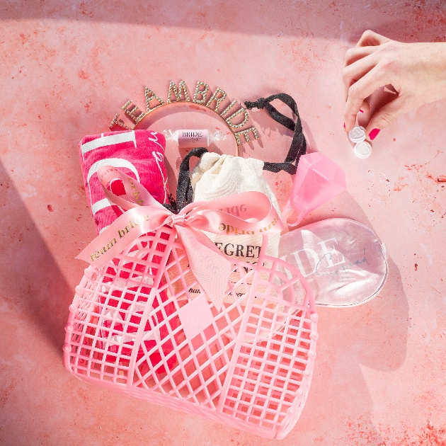 pink jellg bag with lots of accessories put in it