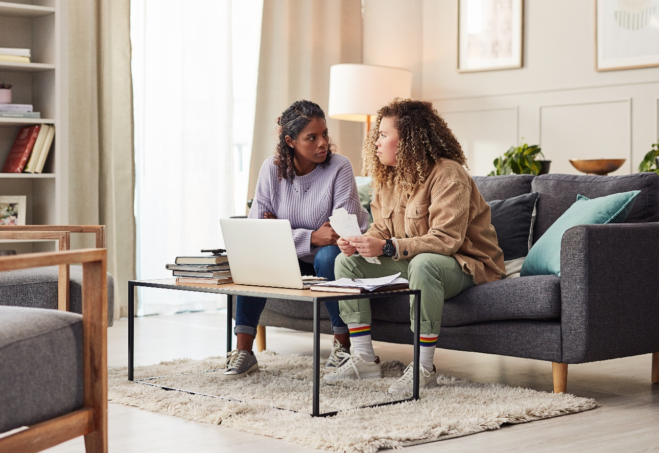 couple on sofa looking at paperwork