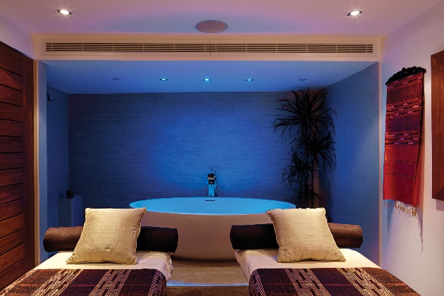 two treatment beds in front of large circle bath