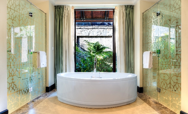 A beautifully decorated bathroom with a bath in the middle of the room