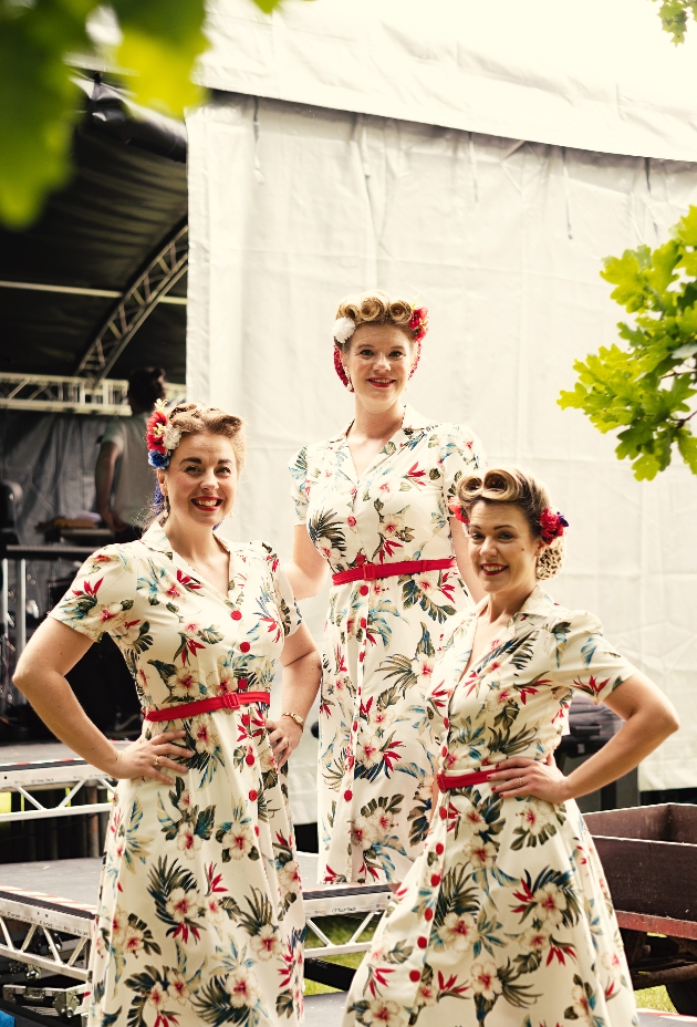 Three ladies wearing sixties matching clothing