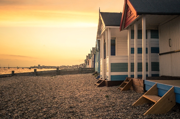 seaside beach huts at sunset