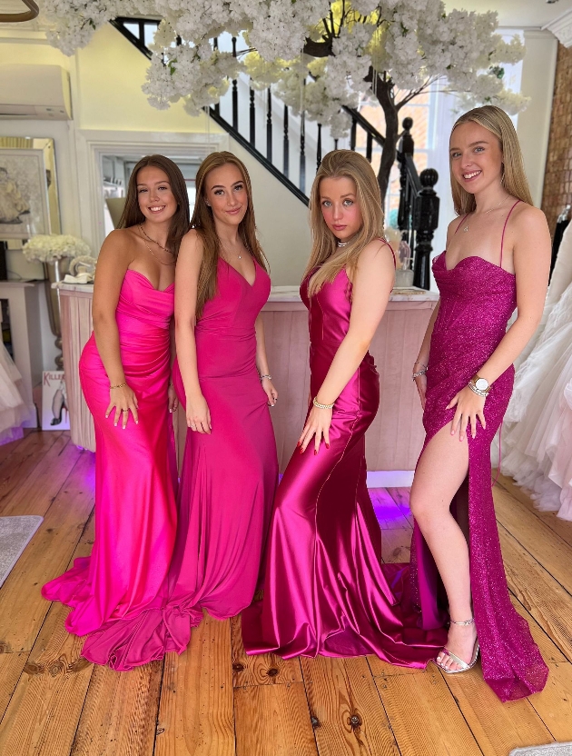Four girls in pink prom dresses