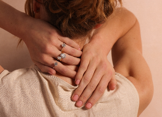 Female clasping hands showing diamond rings