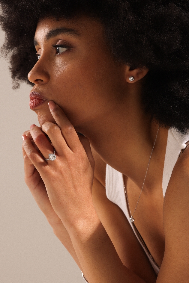 Lady looking into distance showing diamond ring