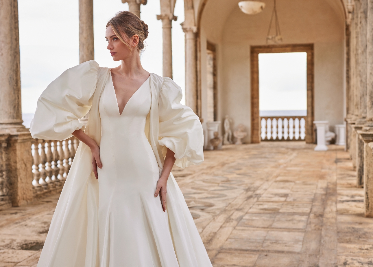 model in gown with large puff ball sleeve bridal coat