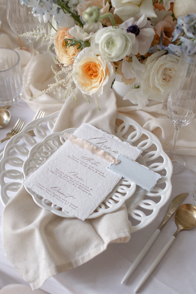 white wedding crockery alongside floral arrangement