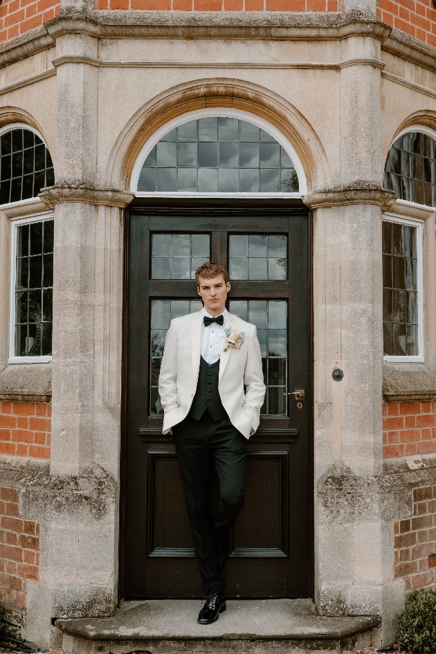 Groom wearing white tuxedo jacket