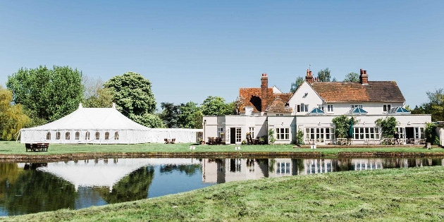 Prested Hall, white wall country house and marquee next to it