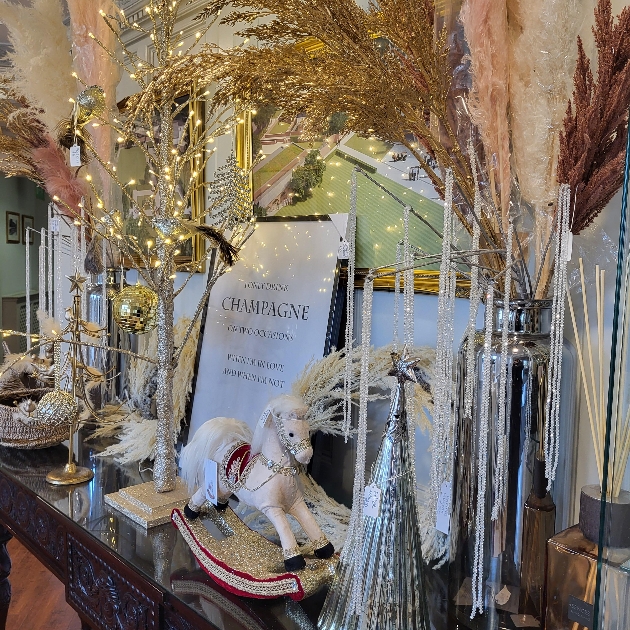 festive table adorned with glittery trees and raffle prizes