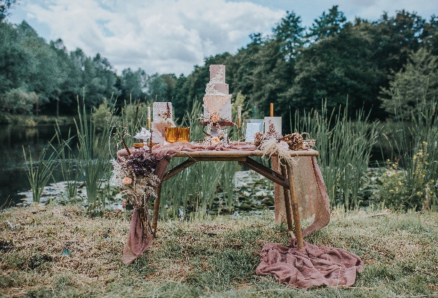 woodland scene with a table with a bridal cake on it