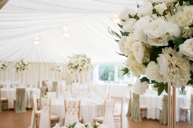 wedding table with white tablecloth and white flowers