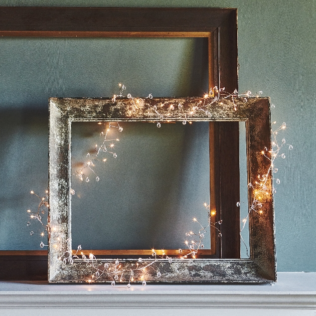 framed mirror adorned with fairylights