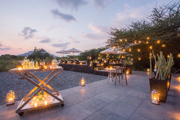 A patio decorated in lights and trees