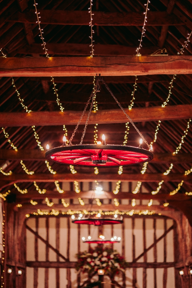 beams lit with fairylights in old barn