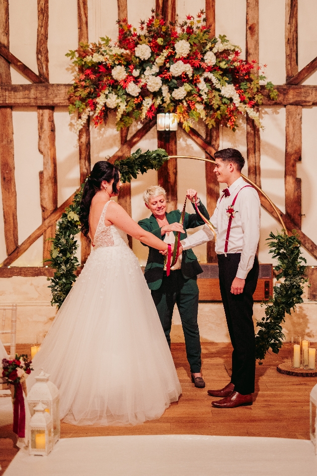 celebrant marrying bride and groom in barn