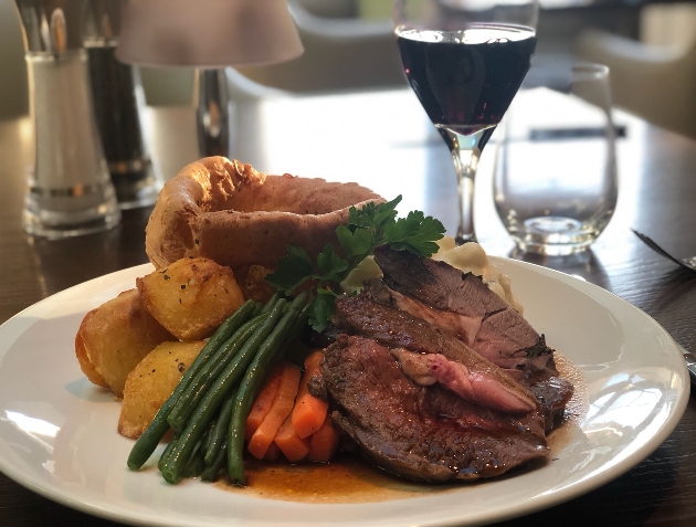 beef roast dinner with glass of red wine