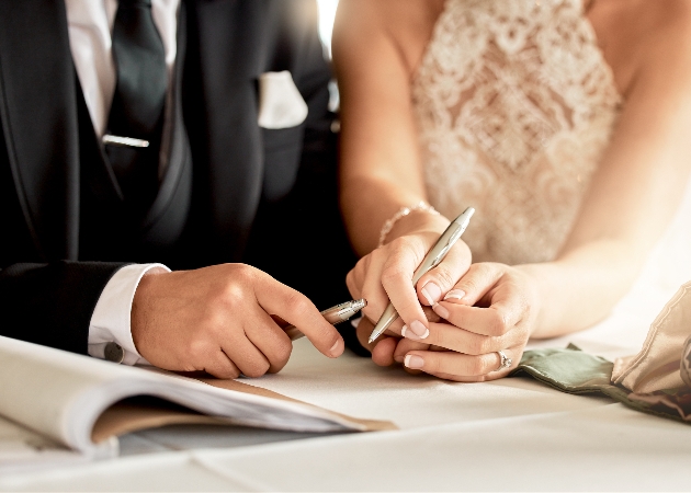 bride and groom signing the register