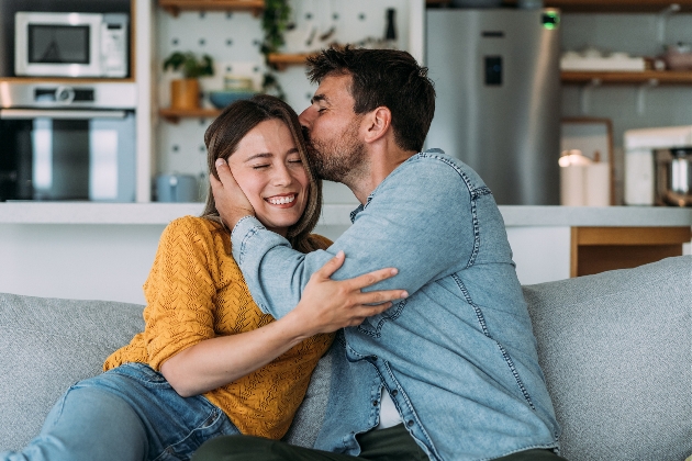 Couple kissing on couch