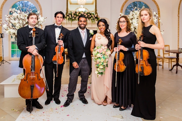 sting quartet with a bride and groom at a venue
