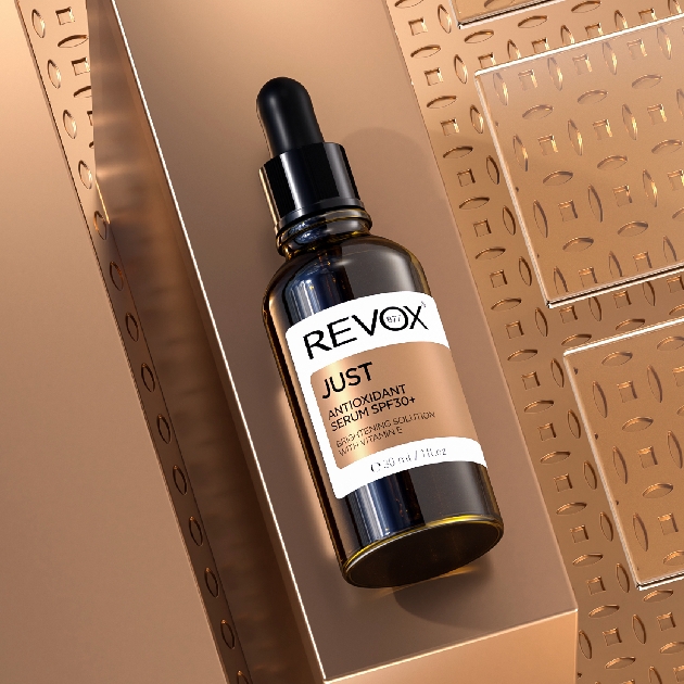 bottle of skin serum on a bronze background