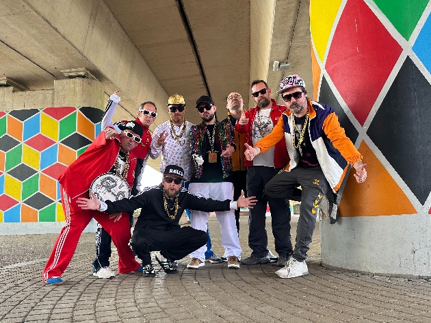 group of men in colourful shellsuits and gold chains