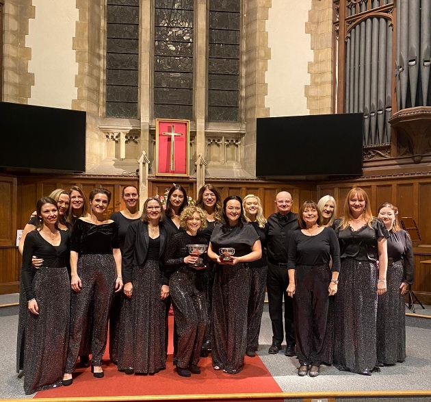 group of women in black gowns standing inside a church