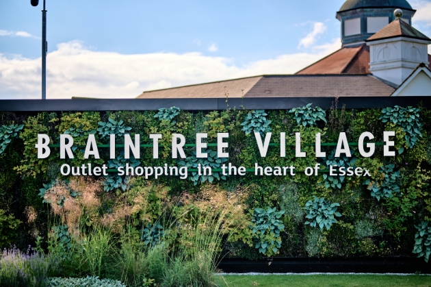 Braintree Village sign on leafy background