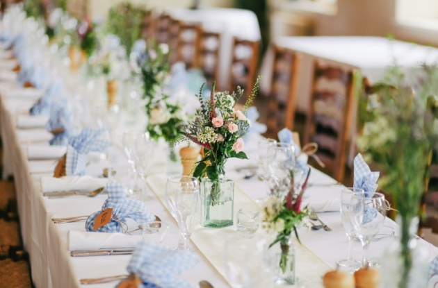 banquet style table setting at wedding with flowers