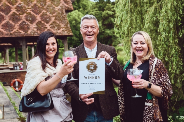 Muddy Stilettos Award winners holding certificate