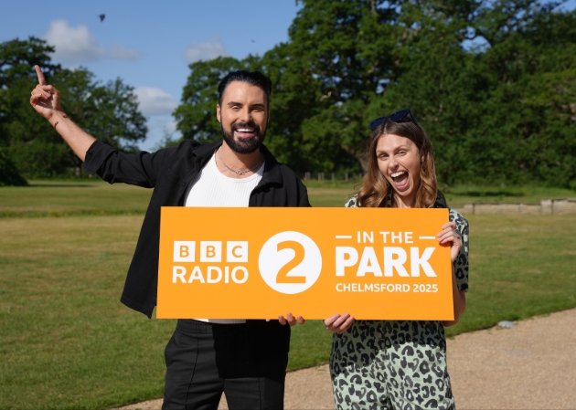 rylan clark holding orange sign