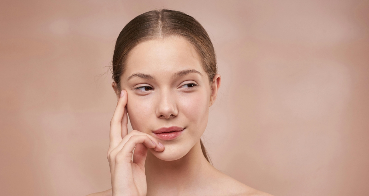 woman with glowing skin looking away from the camera
