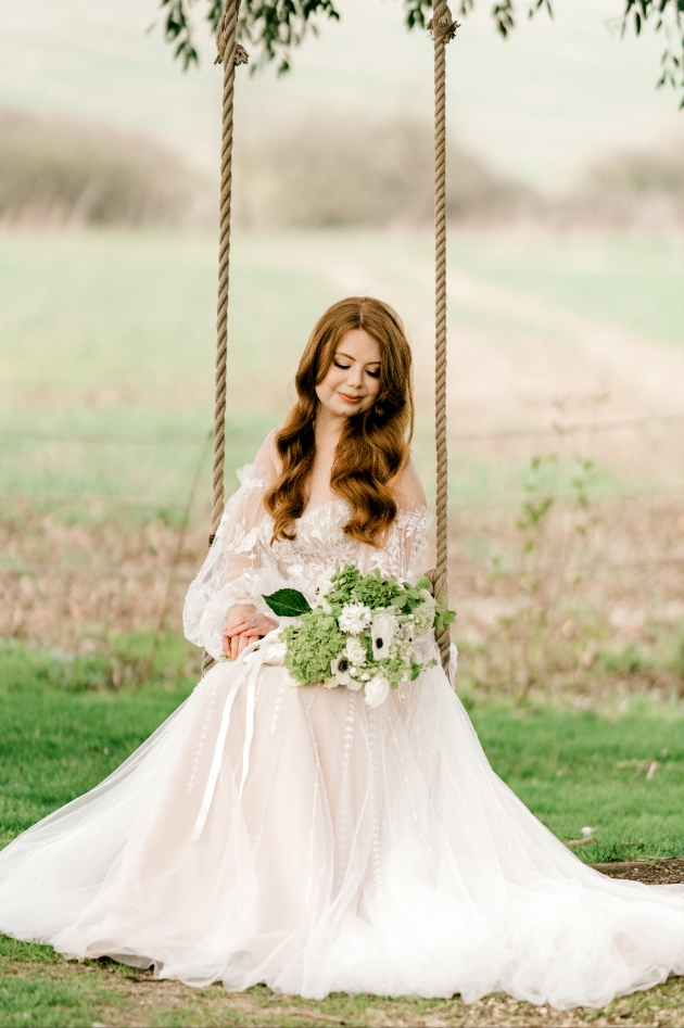 red haired bride on rustic rope swing
