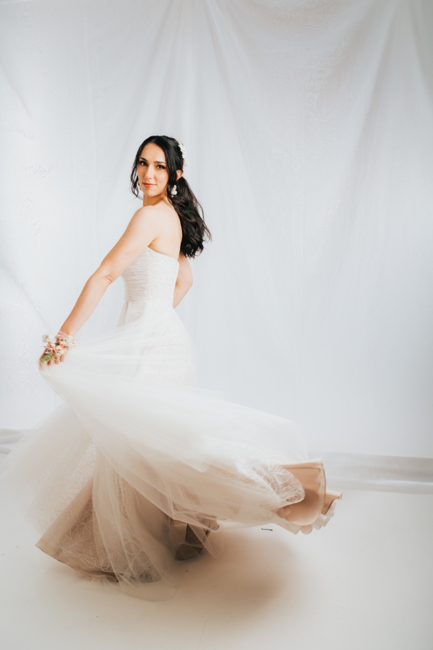 bridal shot of bride spinning in flowing dress