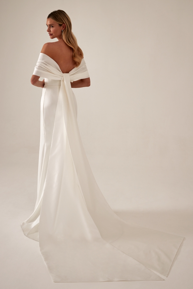 modern in satin column gown with wrap sleeves in to bow at back and long trailing ends